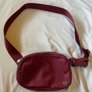 Lululemon Everywhere Belt Bag. Maroon with multi pockets.